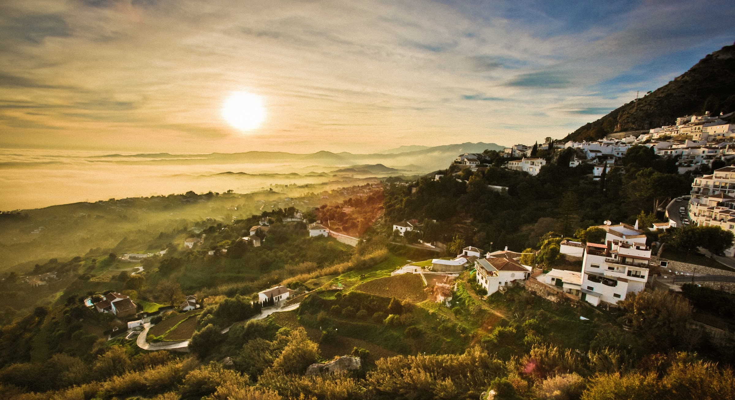 Sunset over Mijas Pueblo and the valley down to the Mediterranean, seen from the Sea to Sky rooftop