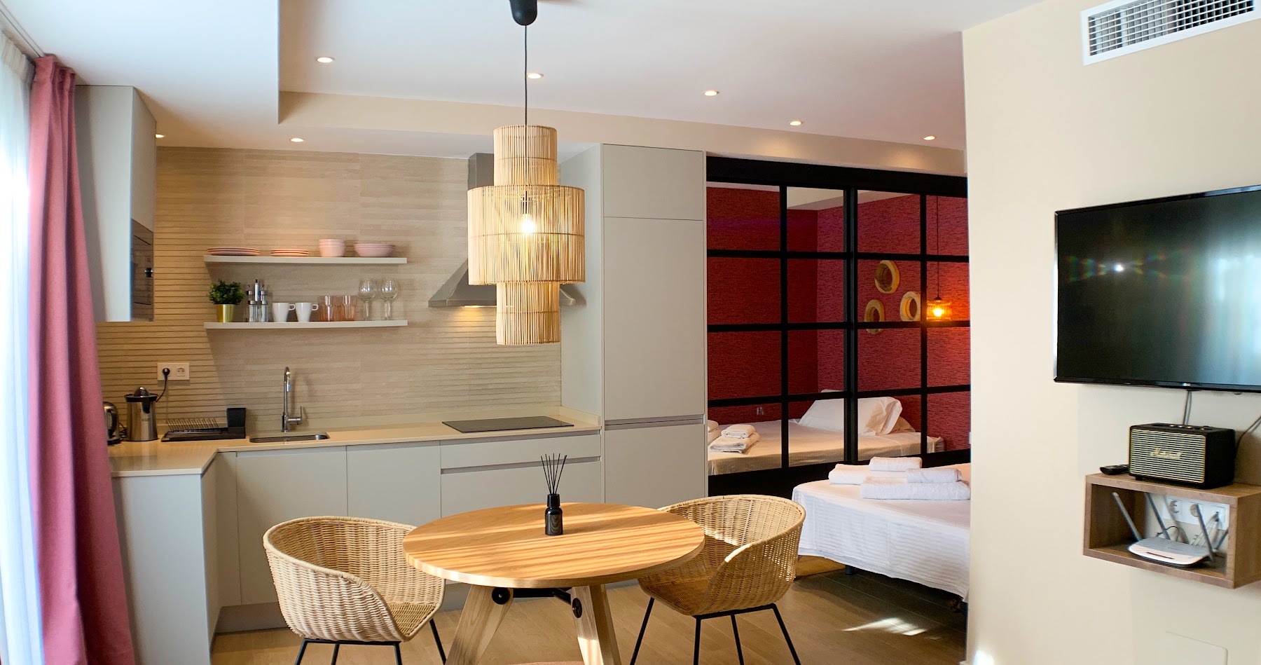 Europa Suite — bed with welcome chocolates against a deep red textured wall
