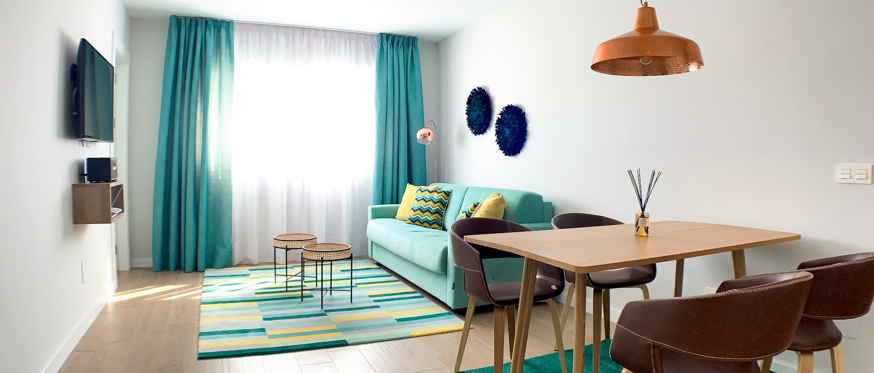 Oceania Suite — turquoise living room and dining, full of Mediterranean light