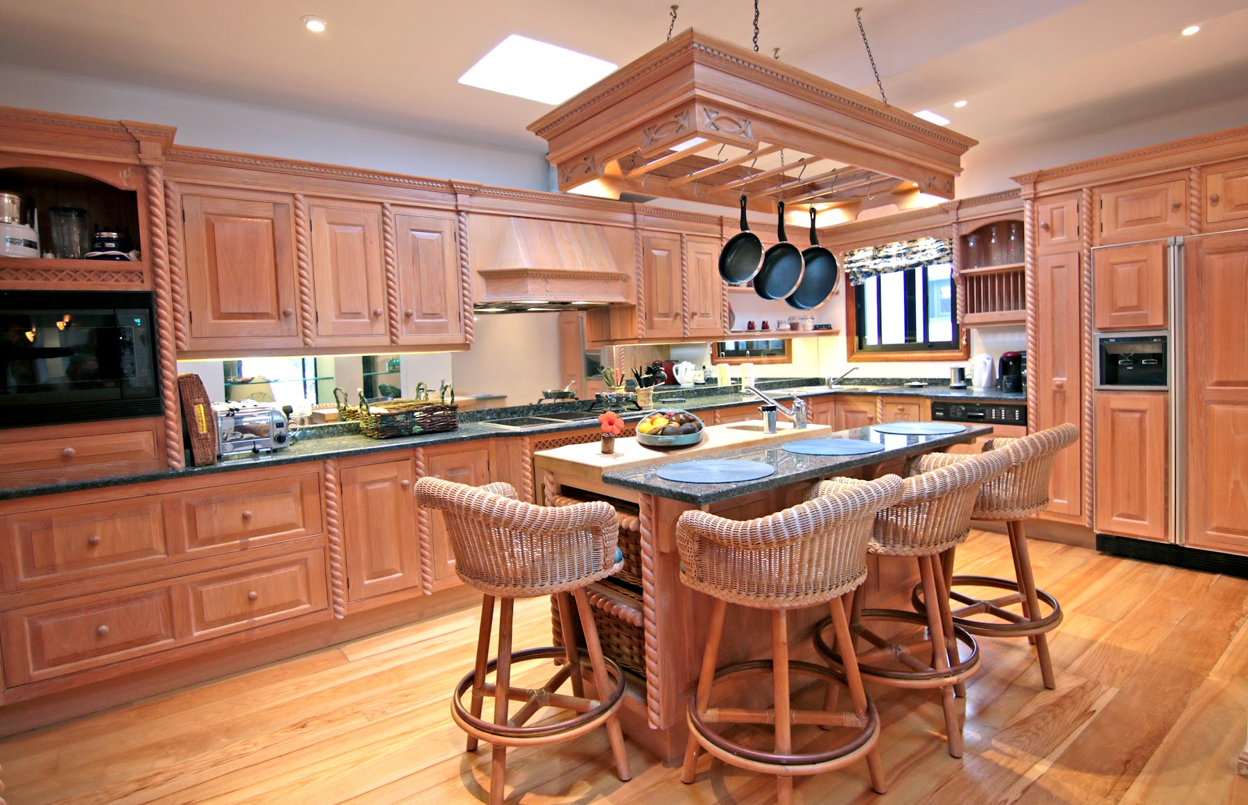 The villa's large timber kitchen with island and bar stools